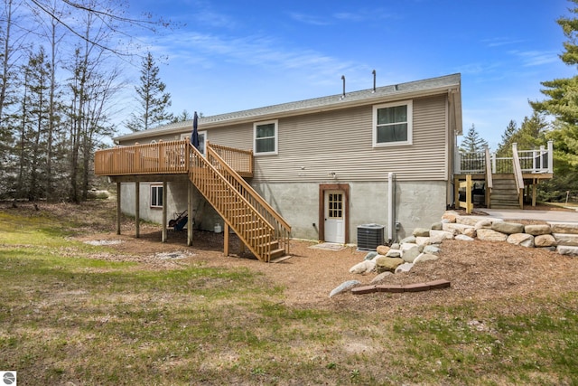 rear view of property featuring central AC unit, a wooden deck, and stairway