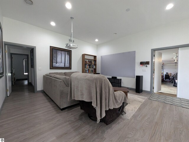 living area with recessed lighting, baseboards, and wood finished floors