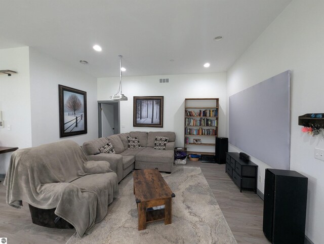 living area featuring recessed lighting, visible vents, and light wood finished floors