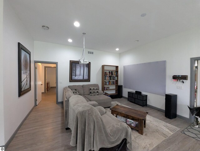 living area featuring recessed lighting, baseboards, visible vents, and light wood-style floors