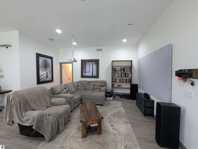 living area featuring recessed lighting, light wood finished floors, and visible vents