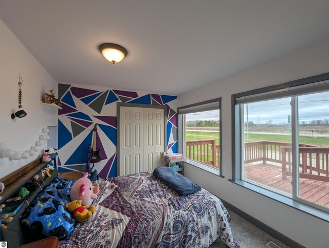 bedroom featuring baseboards, carpet, and access to exterior