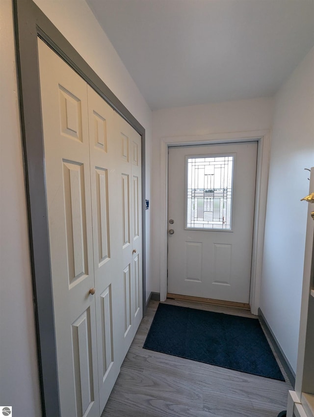 entryway with baseboards and wood finished floors