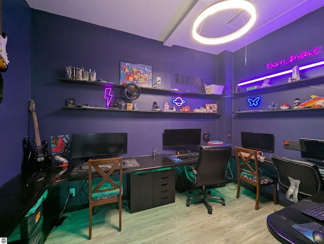 office space featuring wood finished floors and built in study area
