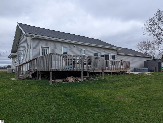 rear view of house with a lawn and a deck