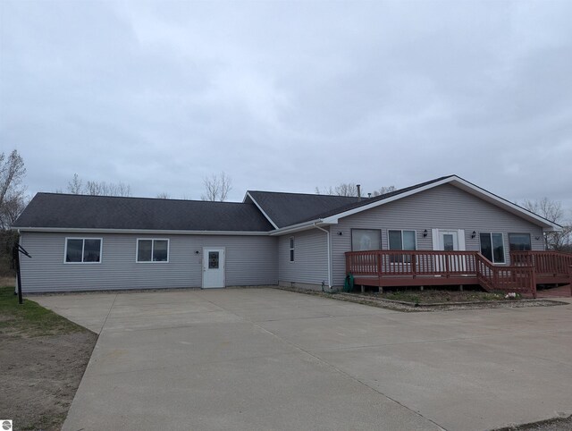 ranch-style home with driveway and a deck