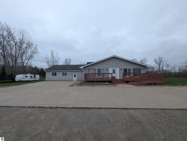 view of front of house with driveway and a deck