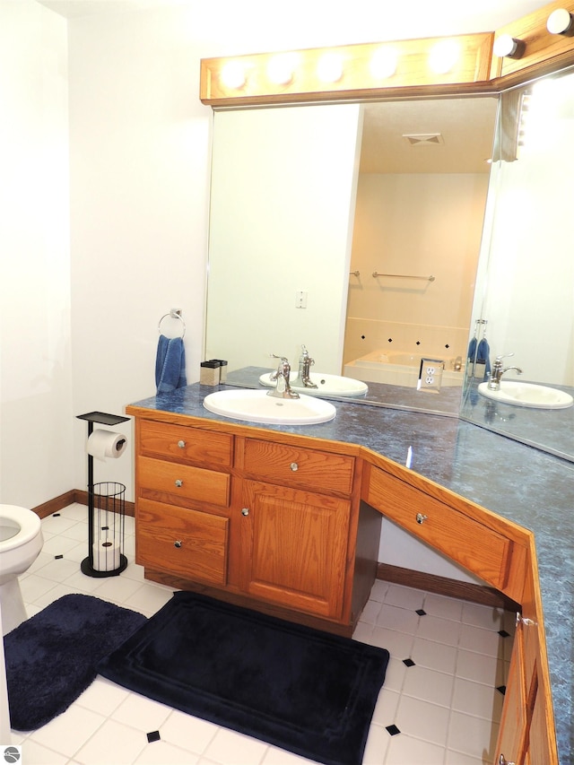 bathroom featuring vanity, tile patterned flooring, visible vents, toilet, and a tub