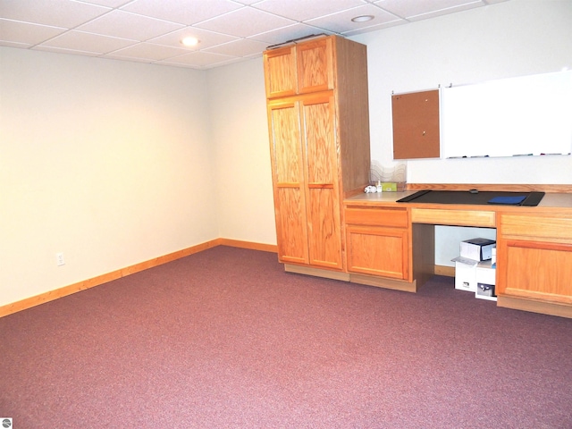 unfurnished office with built in study area, recessed lighting, dark colored carpet, and a paneled ceiling