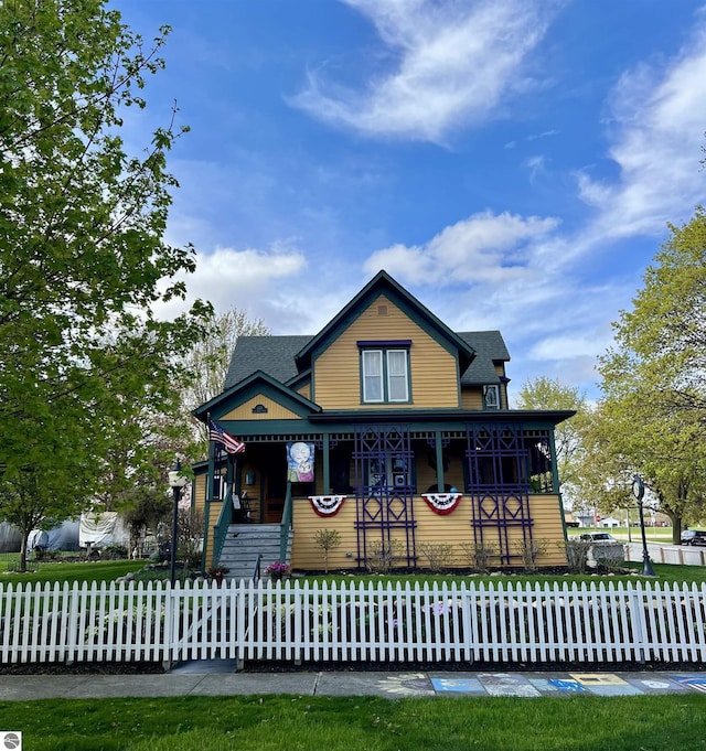view of front of home with roof with shingles and covered porch