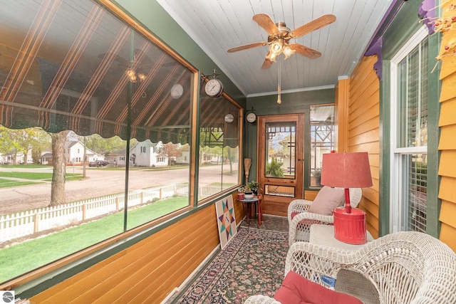 sunroom / solarium with a healthy amount of sunlight and a ceiling fan