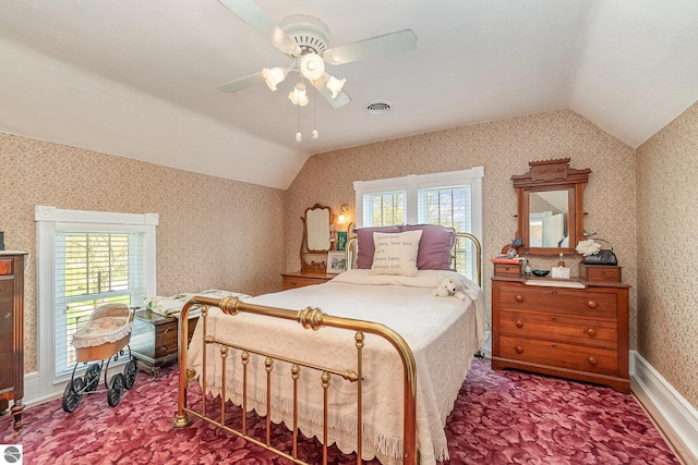 carpeted bedroom with visible vents, ceiling fan, lofted ceiling, and wallpapered walls