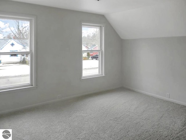 bonus room featuring carpet flooring, baseboards, and lofted ceiling