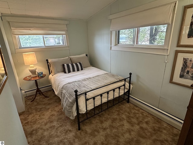 carpeted bedroom with a baseboard heating unit and multiple windows