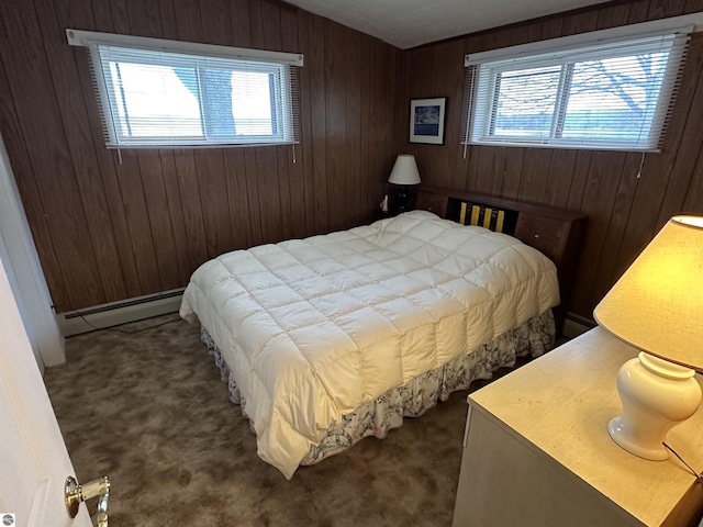 carpeted bedroom with a baseboard heating unit and wooden walls