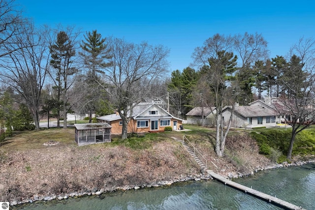 exterior space with a water view, an exterior structure, and a yard