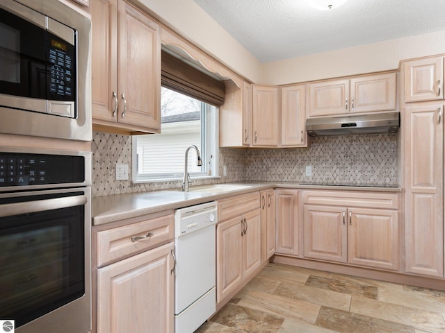 kitchen featuring stainless steel appliances and light brown cabinets
