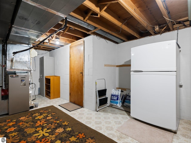 unfinished below grade area with freestanding refrigerator and heating unit