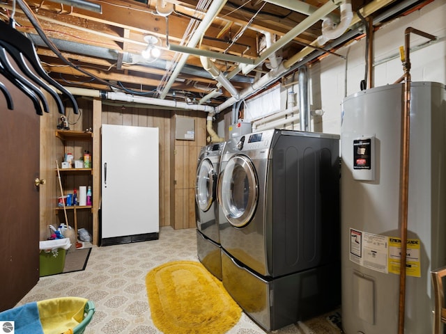 clothes washing area featuring laundry area, water heater, and washer and dryer