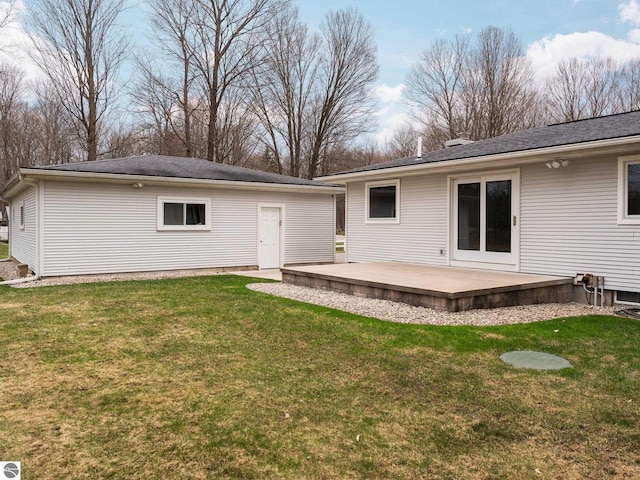 rear view of property with a lawn and a wooden deck