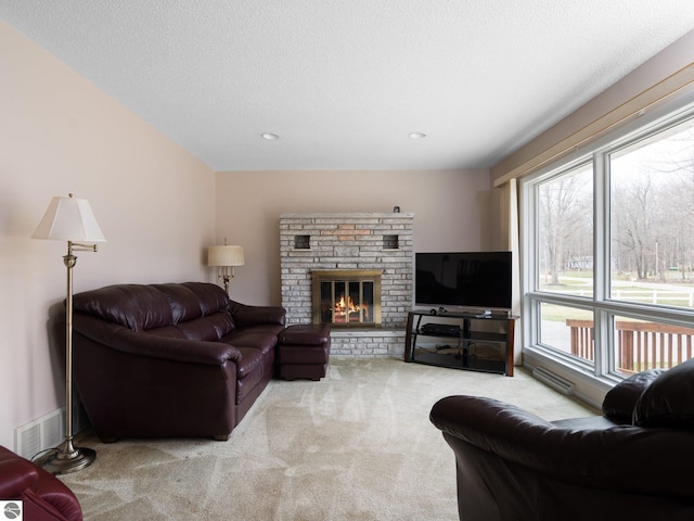 carpeted living room with visible vents, recessed lighting, and a fireplace