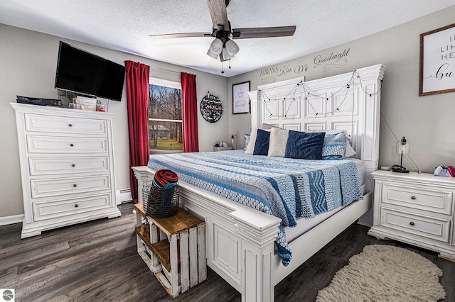 bedroom with dark wood-type flooring, a baseboard radiator, a textured ceiling, and ceiling fan