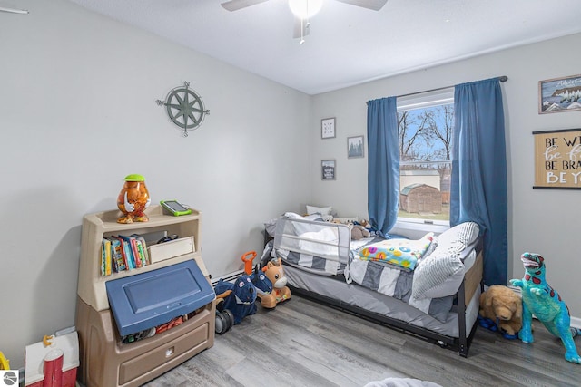 bedroom with ceiling fan and wood finished floors