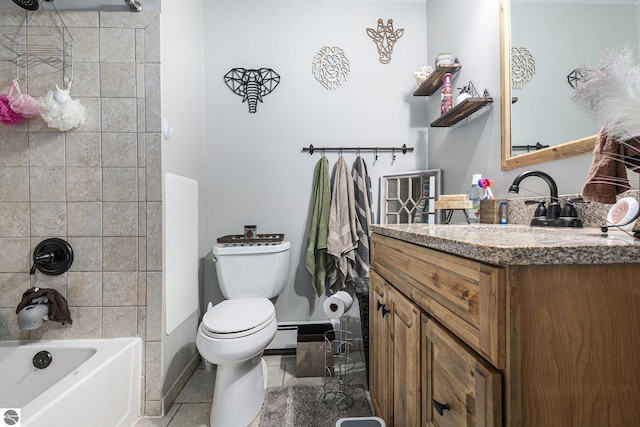 bathroom featuring tile patterned flooring, vanity, baseboards, toilet, and bathing tub / shower combination