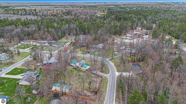 bird's eye view featuring a residential view and a wooded view