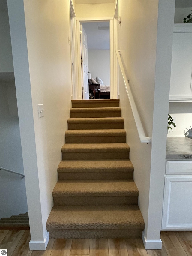 staircase with wood finished floors