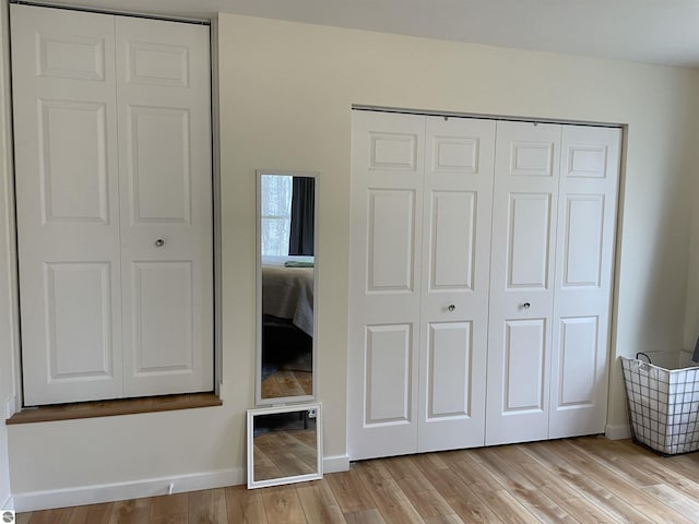 unfurnished bedroom featuring baseboards and light wood-type flooring