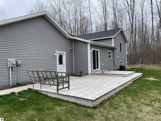 back of house with a lawn and a wooden deck