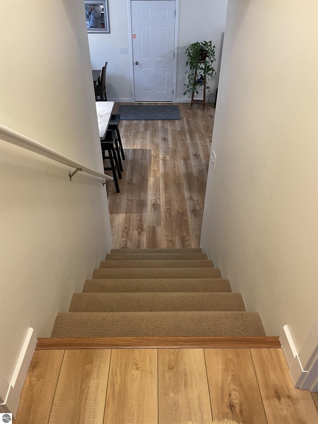 staircase with wood finished floors
