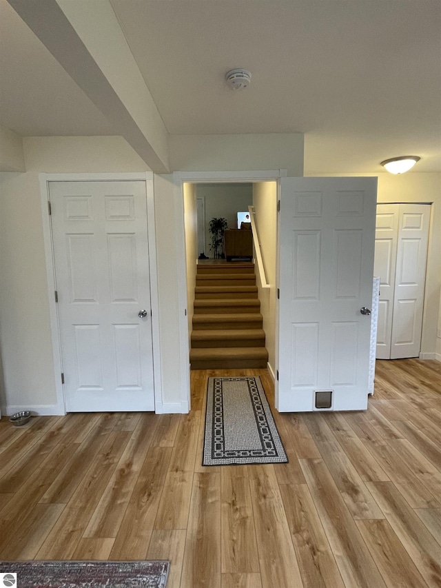 stairs featuring baseboards and wood finished floors