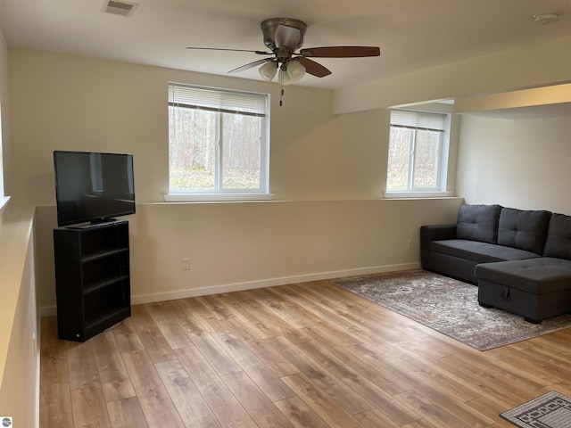 unfurnished living room featuring a ceiling fan, baseboards, visible vents, and light wood-style flooring