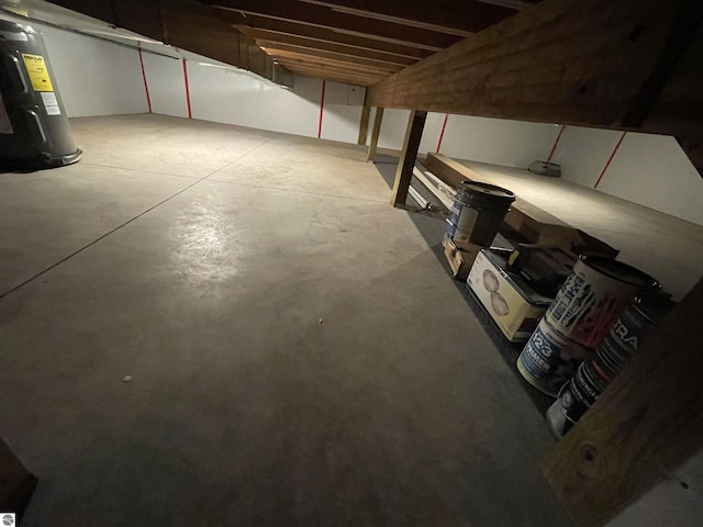 unfinished basement featuring electric water heater