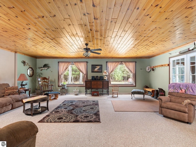 living area featuring crown molding, carpet flooring, a ceiling fan, and wooden ceiling