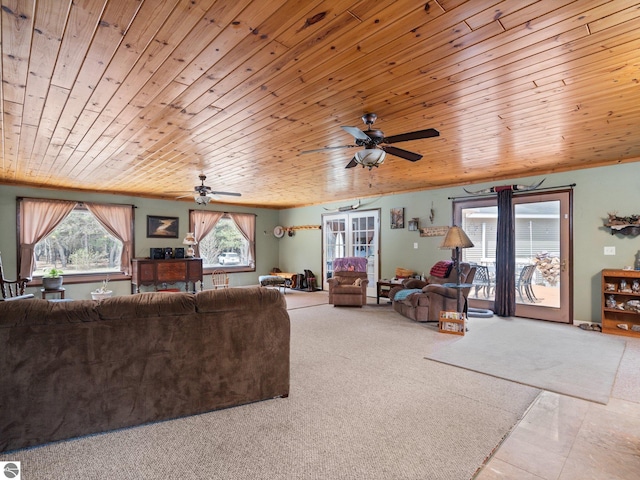 living area featuring carpet flooring, a ceiling fan, and wooden ceiling