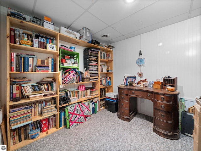 carpeted home office featuring a paneled ceiling