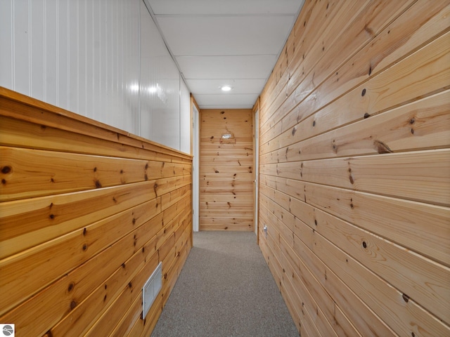 hall featuring wooden walls, carpet flooring, recessed lighting, and visible vents