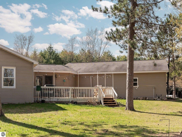 view of front facade with a deck and a front yard