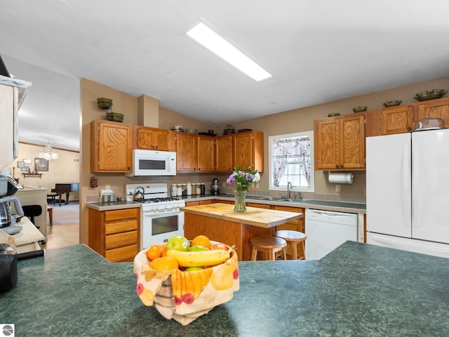 kitchen with brown cabinetry, a sink, butcher block counters, lofted ceiling, and white appliances