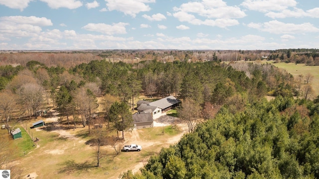 drone / aerial view featuring a wooded view
