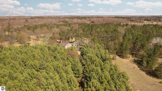 birds eye view of property with a view of trees