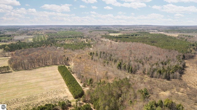 aerial view featuring a forest view and a rural view