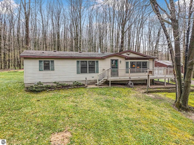 manufactured / mobile home with a wooden deck and a front yard
