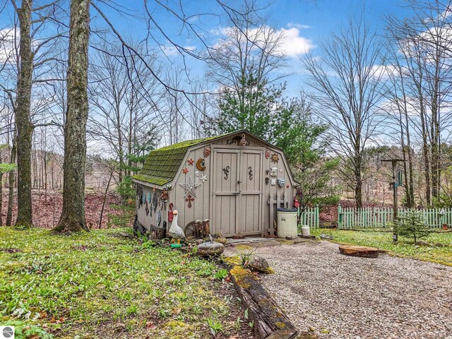 view of shed featuring fence