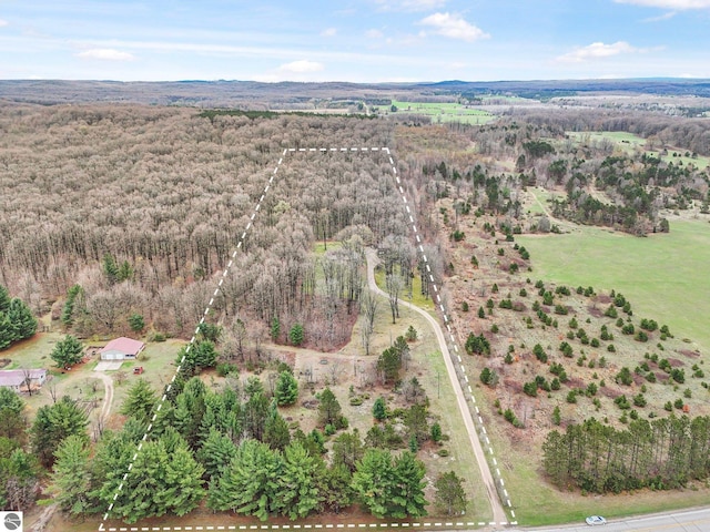 birds eye view of property with a view of trees
