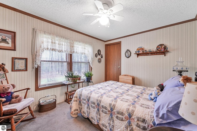 carpeted bedroom with crown molding, a ceiling fan, and a textured ceiling
