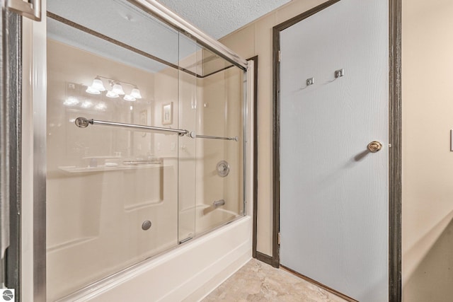 bathroom featuring enclosed tub / shower combo and a textured ceiling
